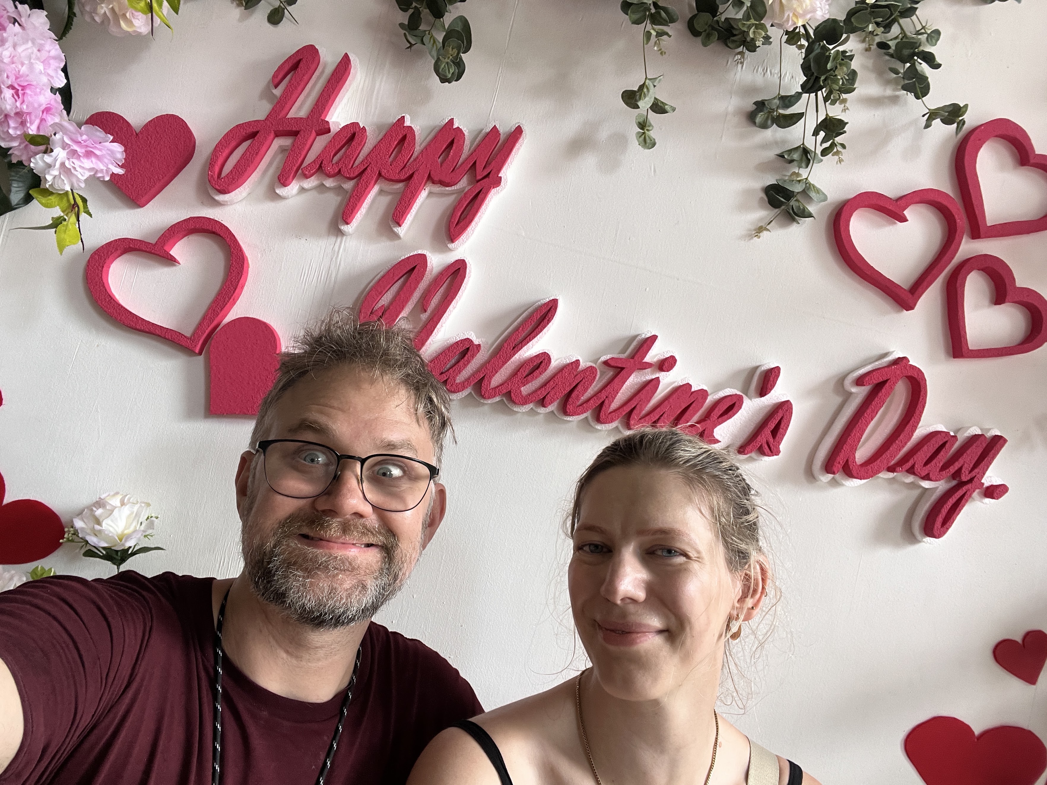 Sarah and Tommy beneath a Happy Valentine’s Day sign